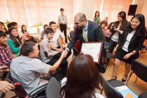 CEO of AKF Kyrgyzstan gives Meder Usupbekov his winning grant