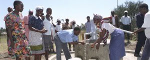 Villagers using a new water pump in rural Kenya