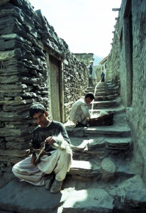 Young men spinning wool 
