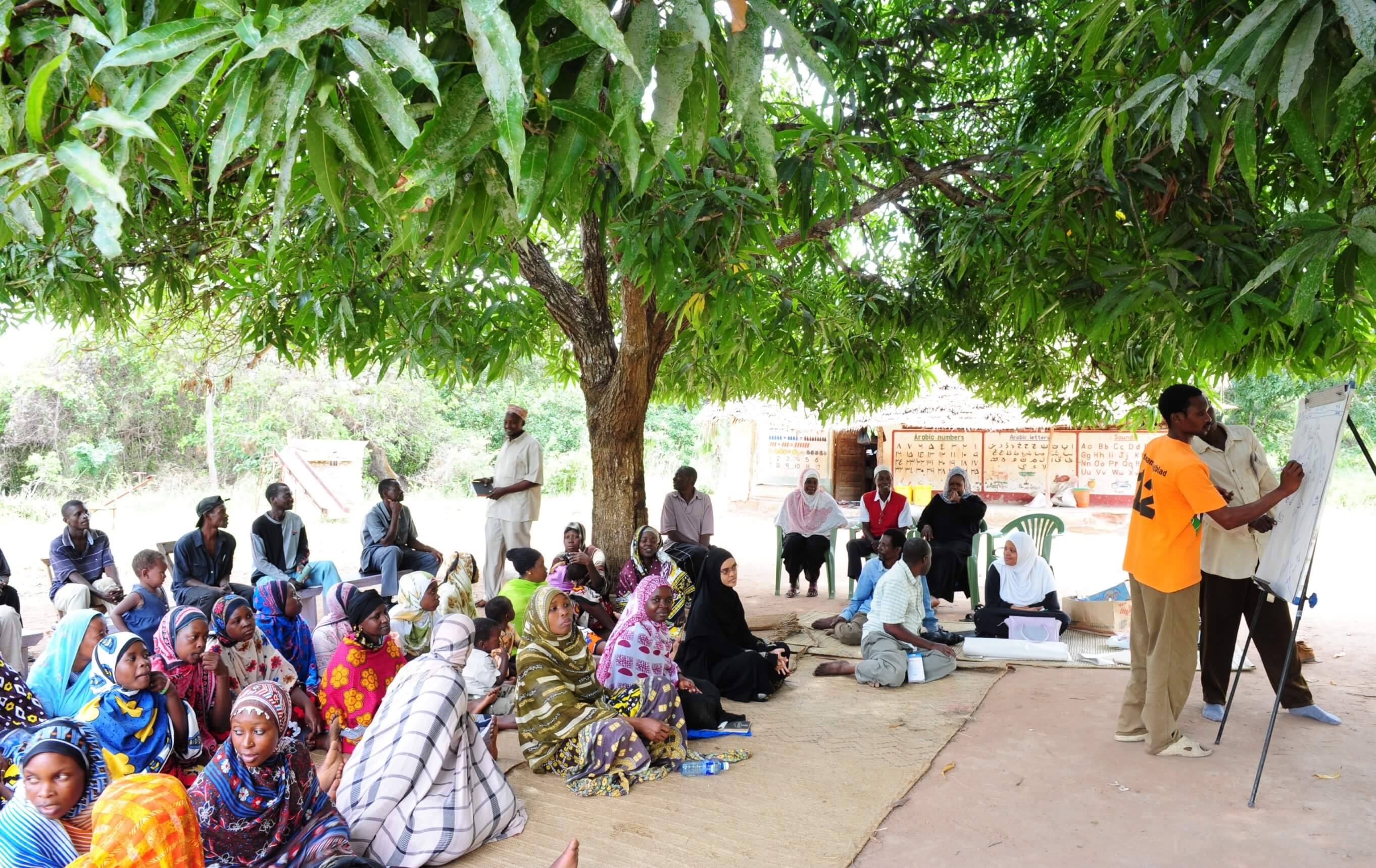 A community group in Kenya meets to discuss educational needs