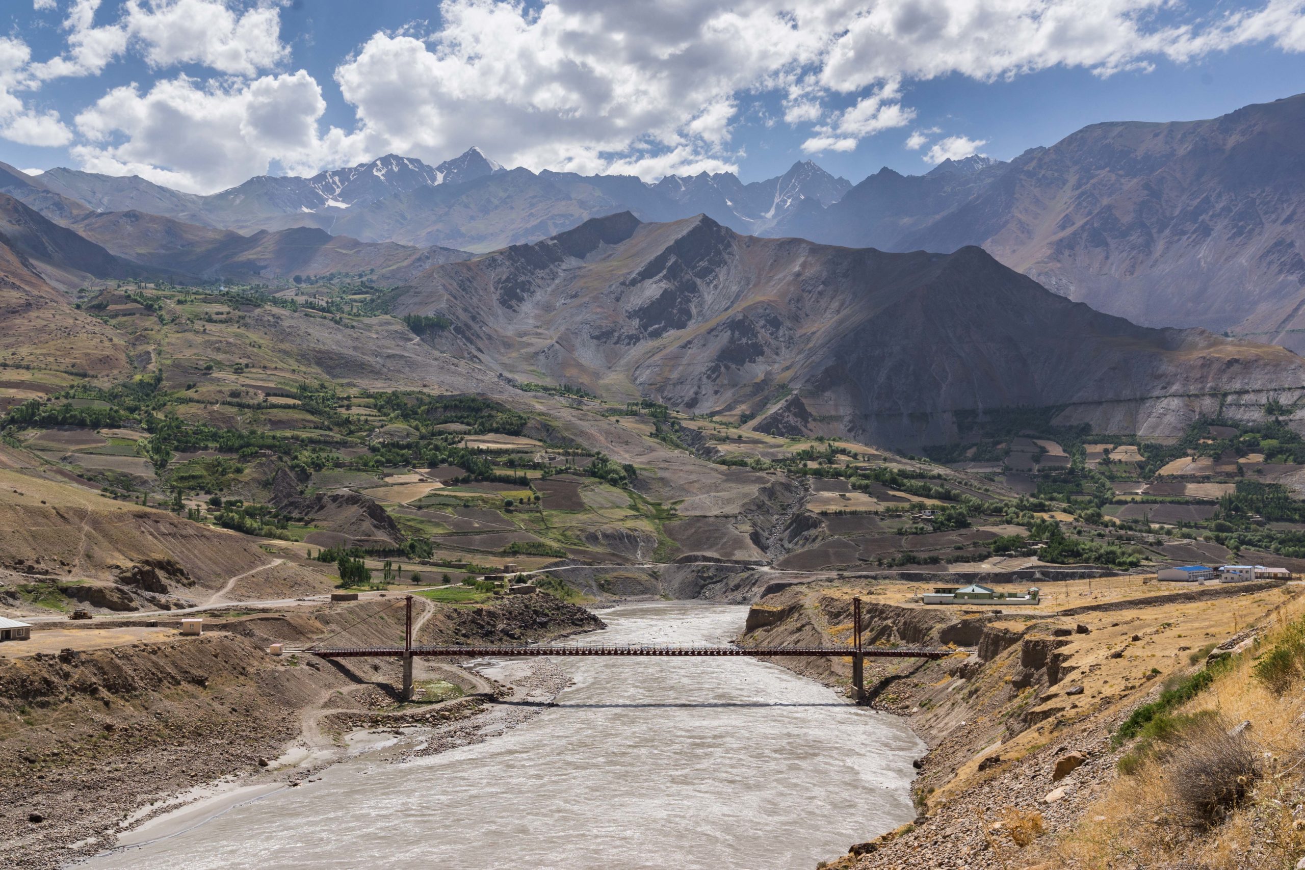 A bridge over a river with mountains in the background. Vanj Cross-Border Bridge photo: Christoper Wilton-Steer | AKDN