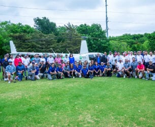 Dallas Golf participants in front of the ball drop helicopter.