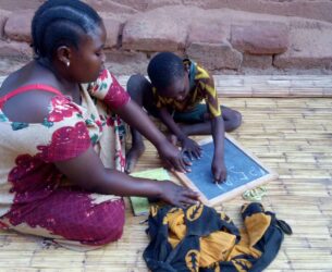 Hussein and Swaumu, his mother, working through his lessons