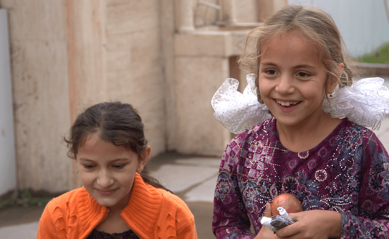 Two Tajik school girls laughing