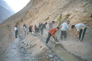 Villagers working together on a new irrigation canal in Vazgulam Valley, Tajikistan