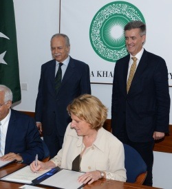 Overseas Private Investment Corporation President and CEO Elizabeth L. Littlefield (seated right) and Aga Khan University President and CEO Firoz Rasul (seated right), on behalf of the Aga Khan Hospital and Medical College Foundation, sign a Loan Agreement to provide financing for expansion of the Aga Khan University Hospital. U.S. Ambassador to Pakistan Richard Olson (standing right) and Chairman of the Board of Trustees of the Aga Khan University Ambassador Saidullah Khan Dehlavi (standing left) officiated at the ceremony.