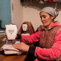 A woman uses a sewing machine