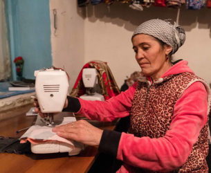 A woman uses a sewing machine