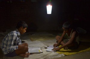 Students studying under a solar powered light.